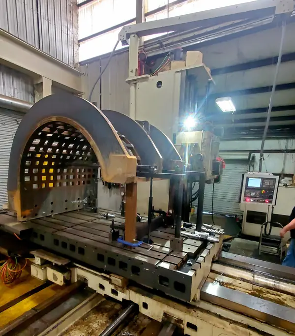 Large curved component being machined on a CNC mill
