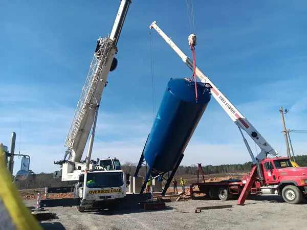Cranes lifting and installing a steel silo
