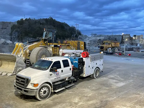 Jones field service truck beside a wheel loader at a quarry