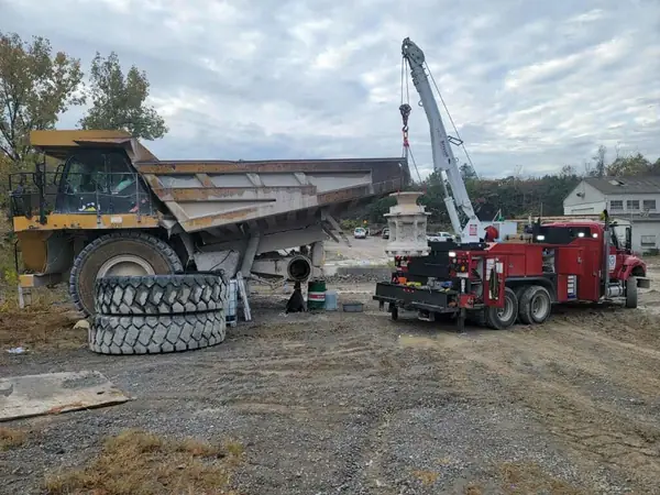 Field service truck repairing a haul truck bed