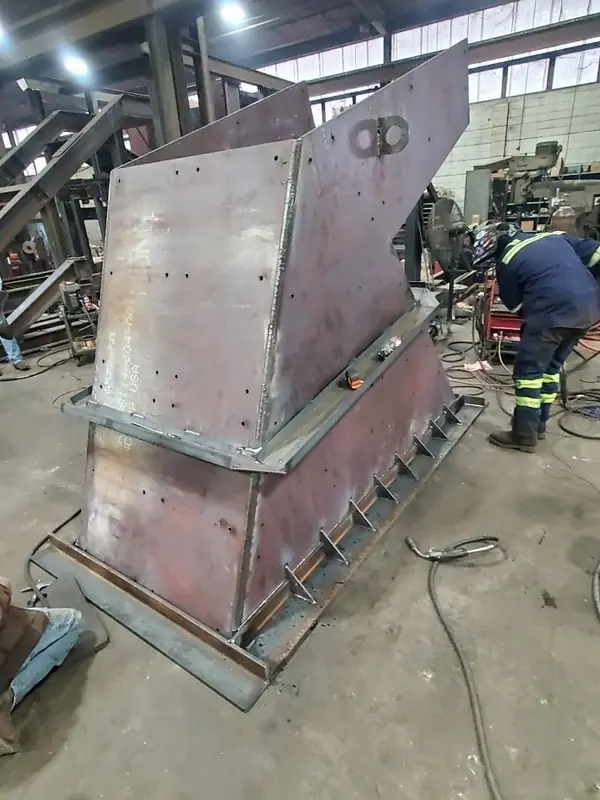 Fitter welding a heavy plate hopper section
