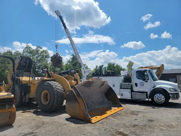 Field service truck working on a loader bucket