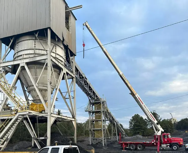 Crane installing conveyor and tower steel at a processing plant