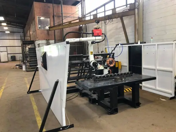 Robotic welder inside its safety enclosure