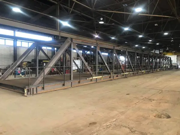 Long fabricated steel trusses on the shop floor