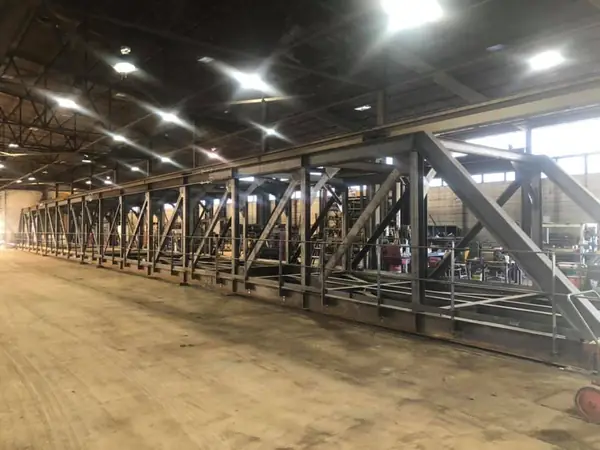 Rows of structural steel trusses in the fabrication shop